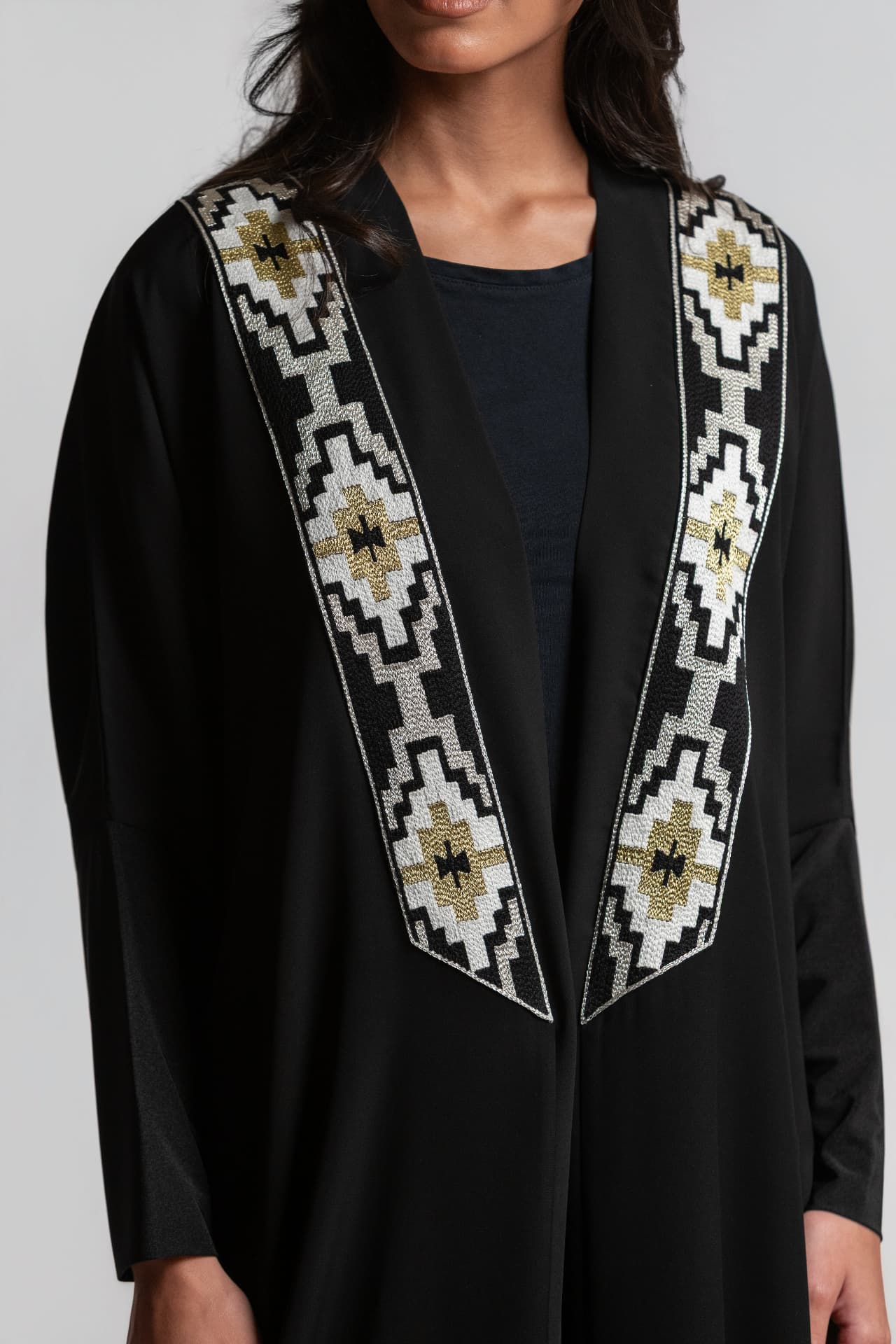 Cream and gold geometric embroidery detail